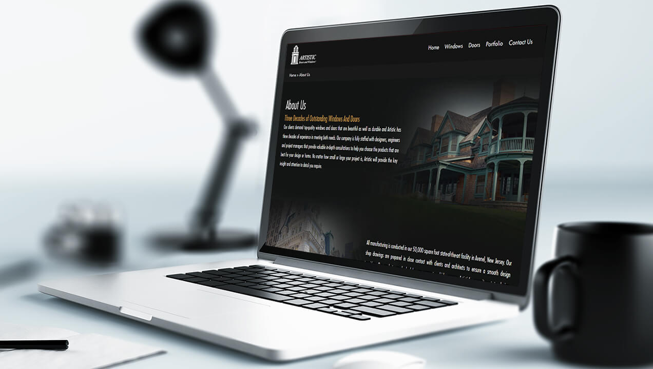 Artistic Doors & Windows website on a laptop