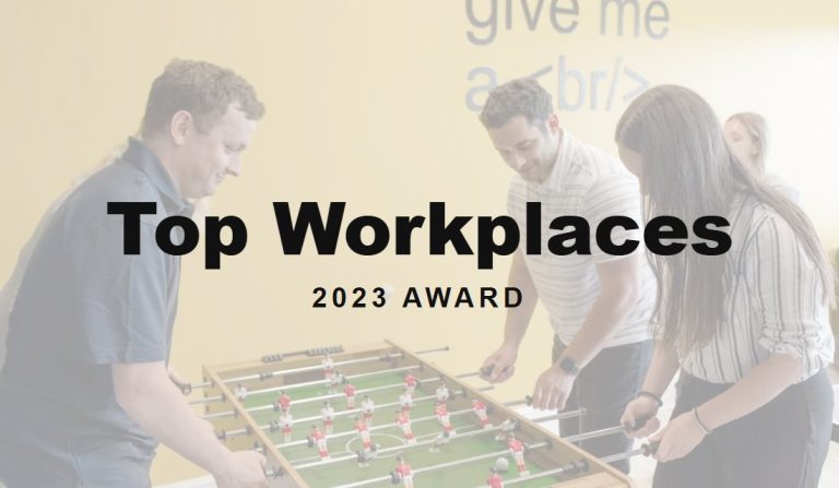 Top Workplaces 2023 award over the SmartSites team at the office foosball table