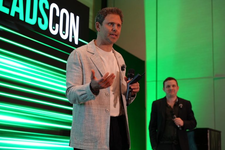 Dr. Alex Rubinov presenting at LeadsCon 2026 with Michael Melen