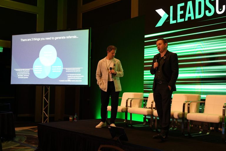 Dr. Alex Rubinov and Michael Melen with the patient referrals slide at LeadsCon 2026