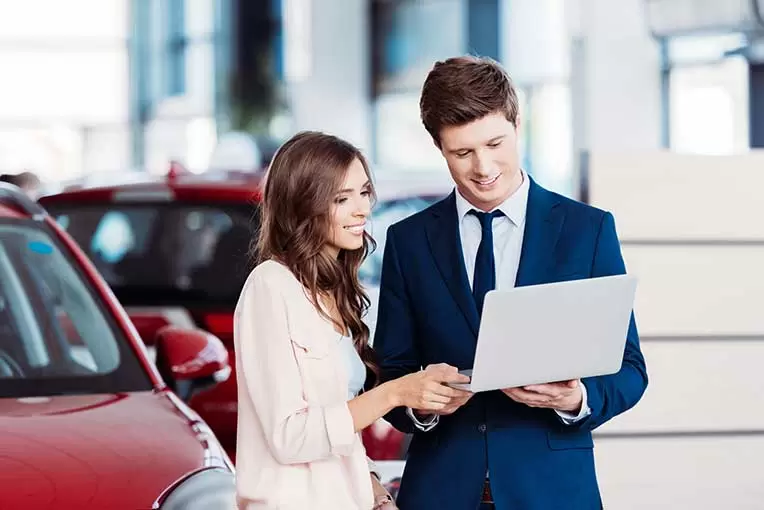 Manager showing something on laptop